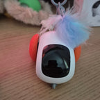 Small electronic device with a feather attachment on a textured surface