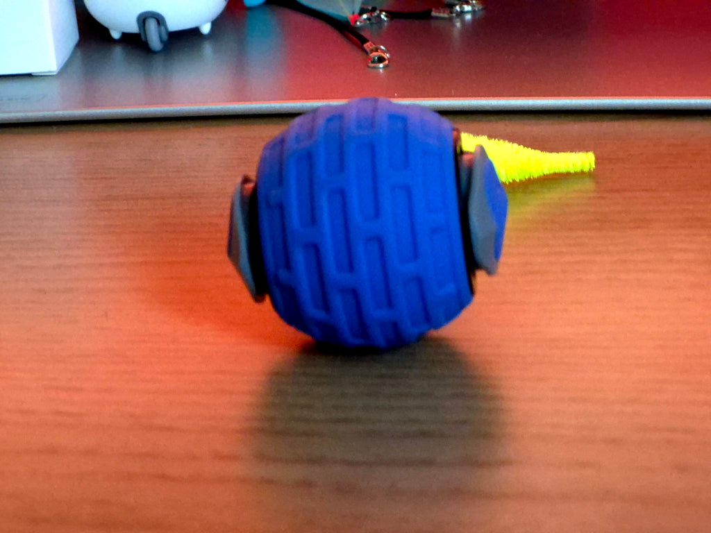 Blue massage roller ball on a wooden surface with blurred background