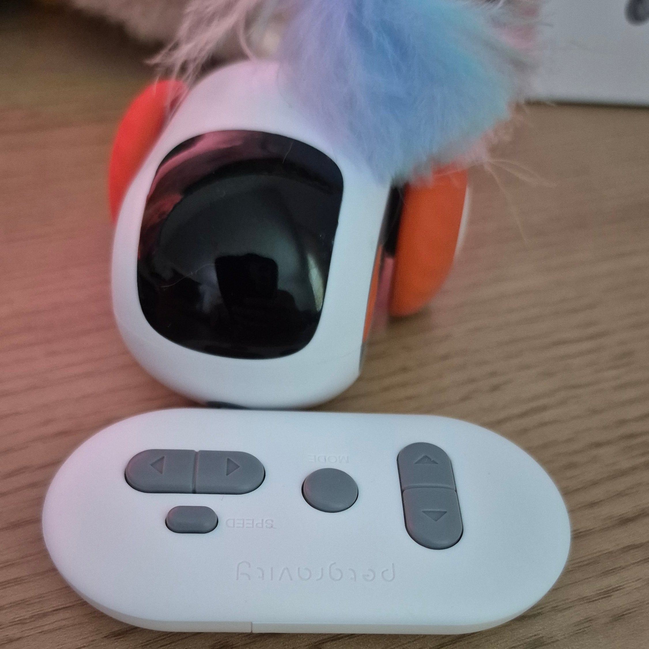 White electronic device with buttons on a wooden surface