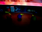 Toy car with colorful lights on a wooden surface