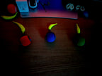 Colorful toy cars on a wooden surface with a dark background