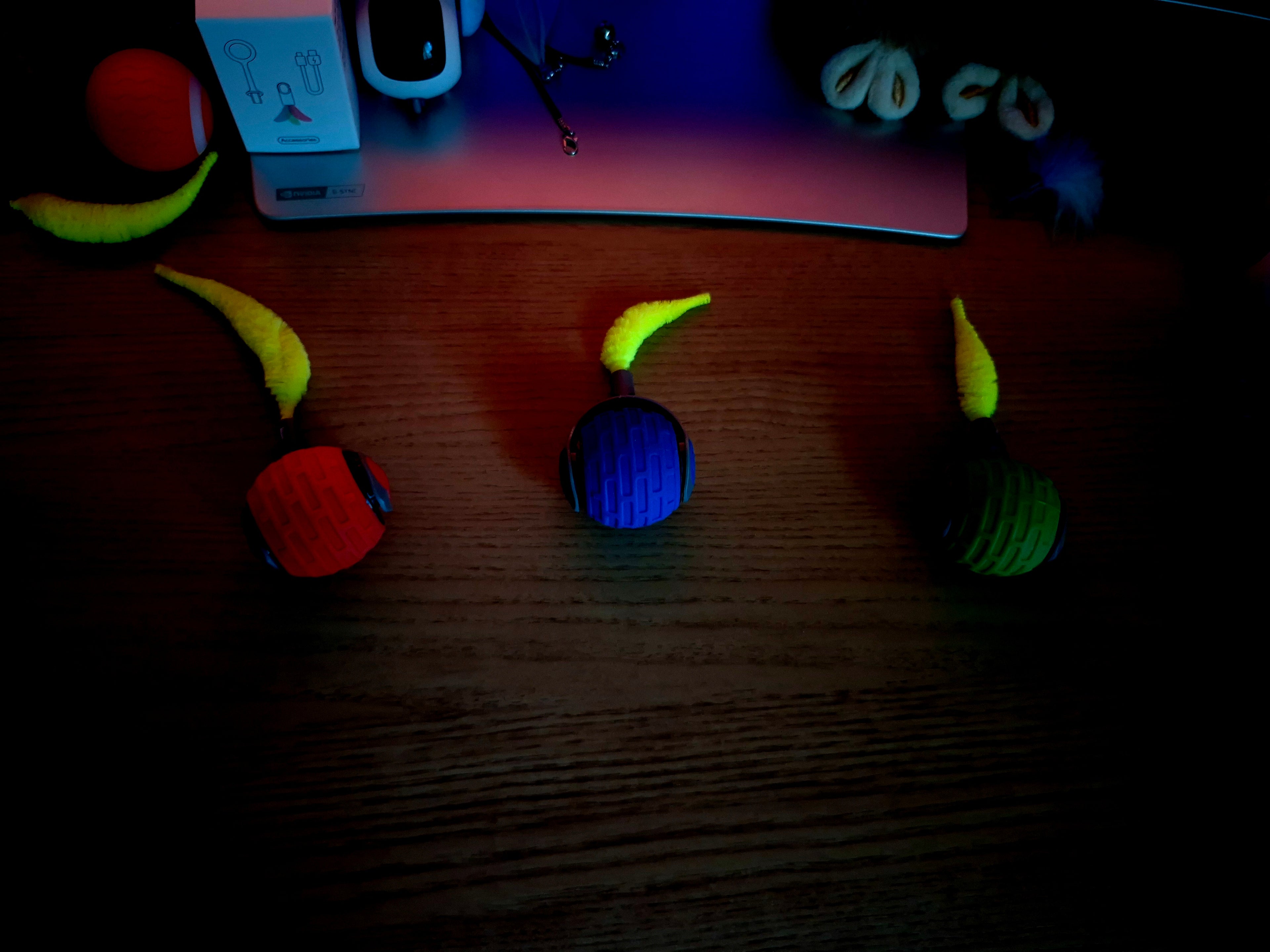 Colorful toy cars on a wooden surface with a dark background